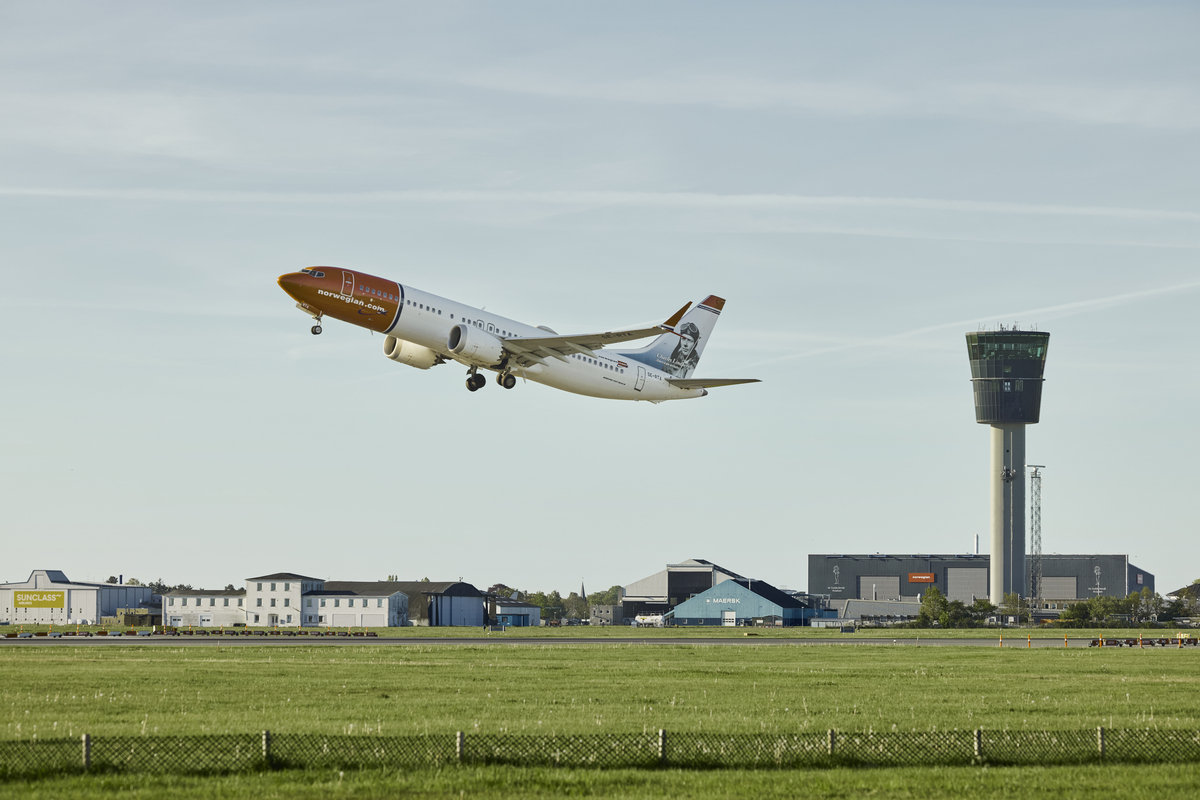 A Norwegian aircraft takes off.