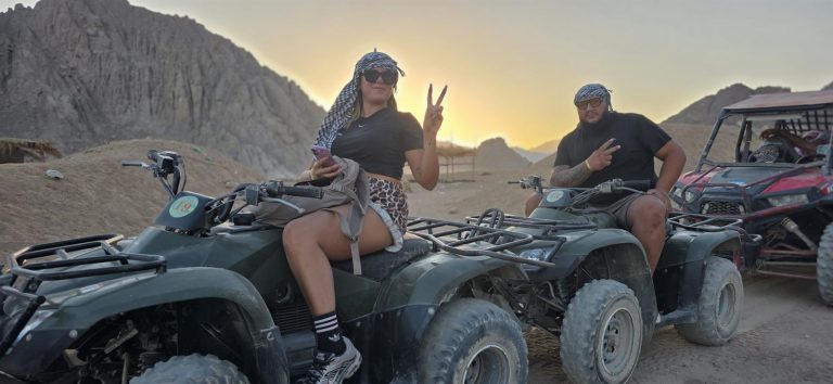 Two guests on quad bikes below the desert mountains at sunset near Sharm El Sheikh