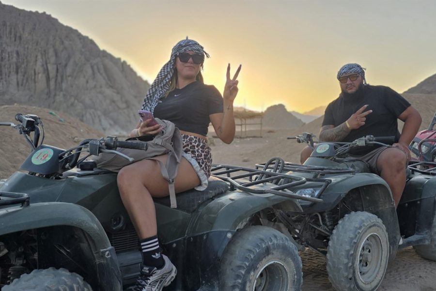 Two guests on quad bikes below the desert mountains at sunset near Sharm El Sheikh